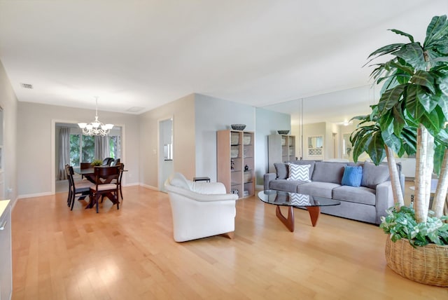 living room with an inviting chandelier and wood-type flooring