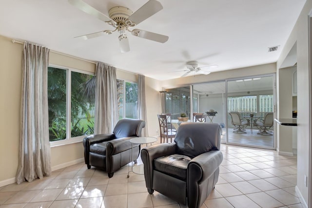 sitting room featuring light tile patterned flooring, ceiling fan, and a wealth of natural light