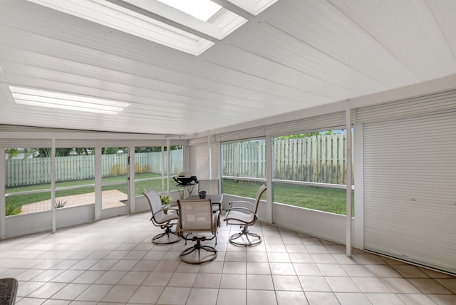 unfurnished sunroom featuring a skylight