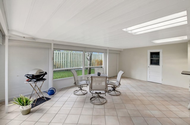 sunroom featuring lofted ceiling