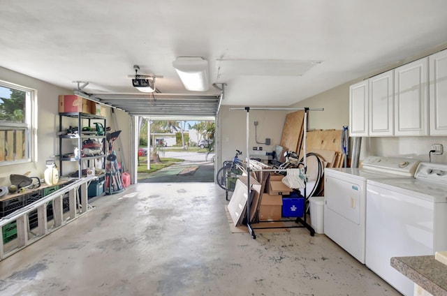 garage with washing machine and dryer and a garage door opener