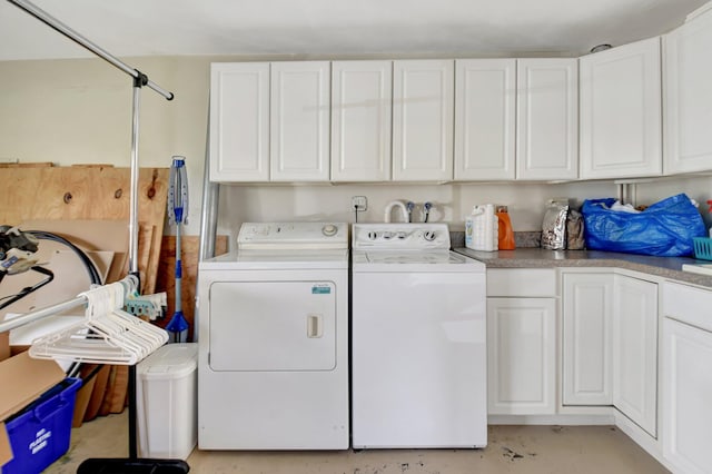 laundry area featuring washer and dryer and cabinets