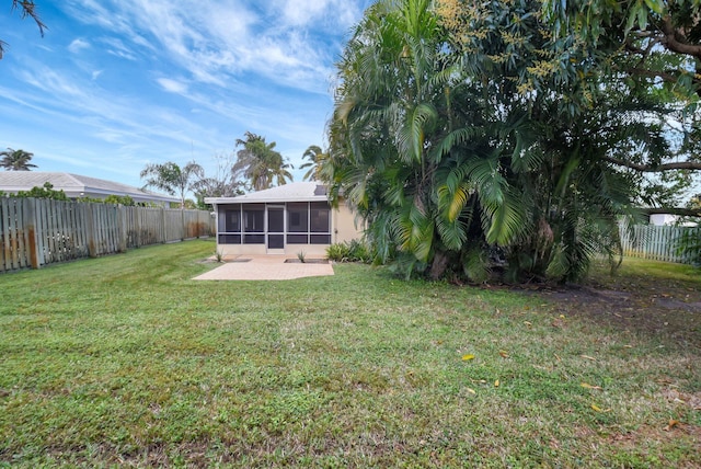 view of yard featuring a patio area and a sunroom