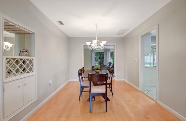 dining room featuring a chandelier and light hardwood / wood-style flooring