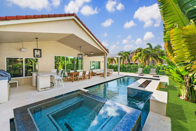 view of swimming pool with a patio area, an outdoor living space with a fire pit, and an in ground hot tub