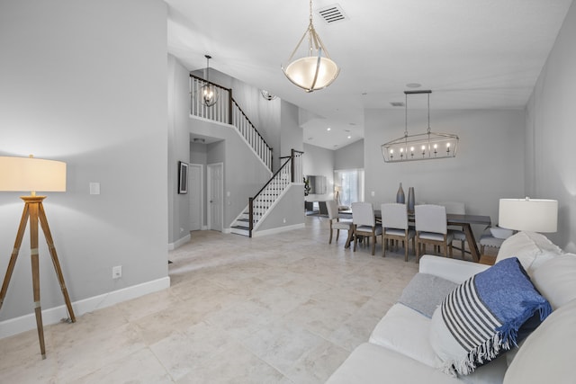 living room with vaulted ceiling and a notable chandelier