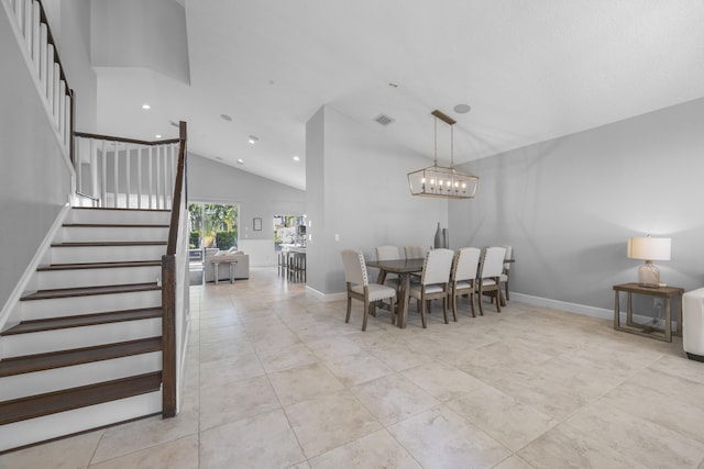 tiled dining area featuring a chandelier and high vaulted ceiling