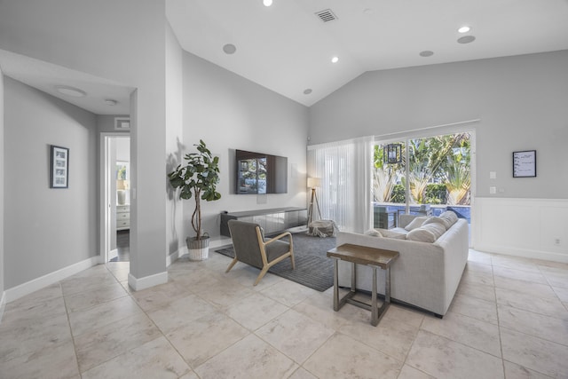 living room featuring high vaulted ceiling and light tile patterned floors