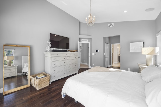 bedroom with vaulted ceiling, a chandelier, and dark hardwood / wood-style floors