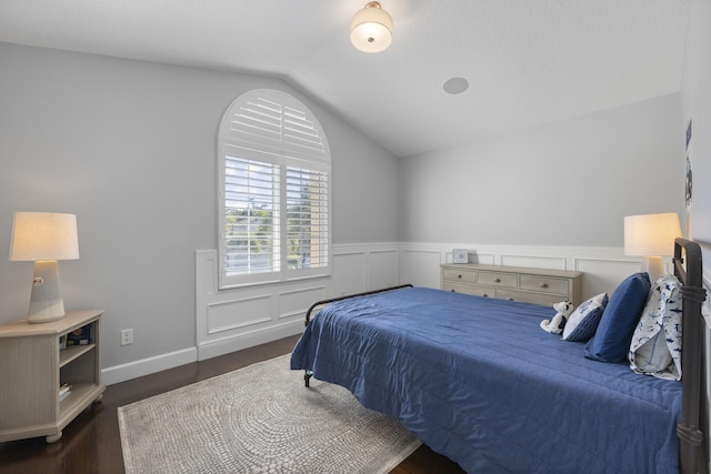 bedroom featuring dark wood-type flooring and lofted ceiling