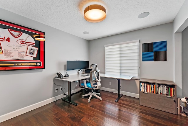 home office with a textured ceiling and dark hardwood / wood-style flooring