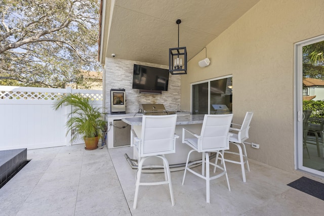 view of patio featuring exterior bar and area for grilling