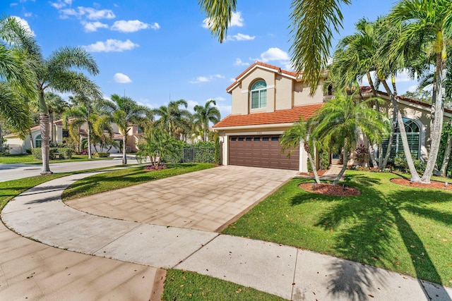 mediterranean / spanish house with a front lawn and a garage