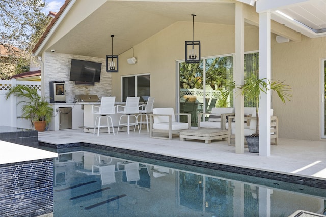 view of pool with an outdoor bar, a patio, and area for grilling