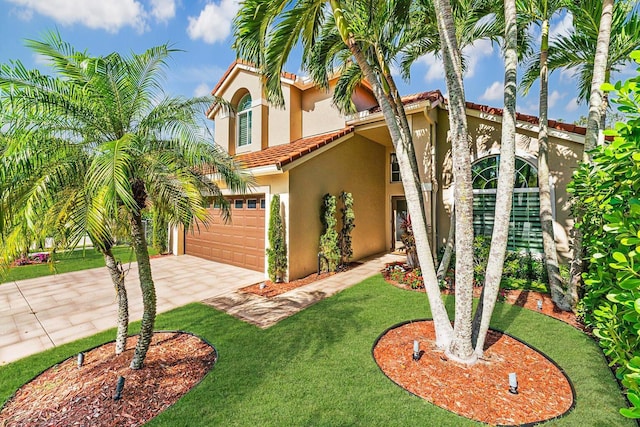 mediterranean / spanish home with a garage and a front lawn