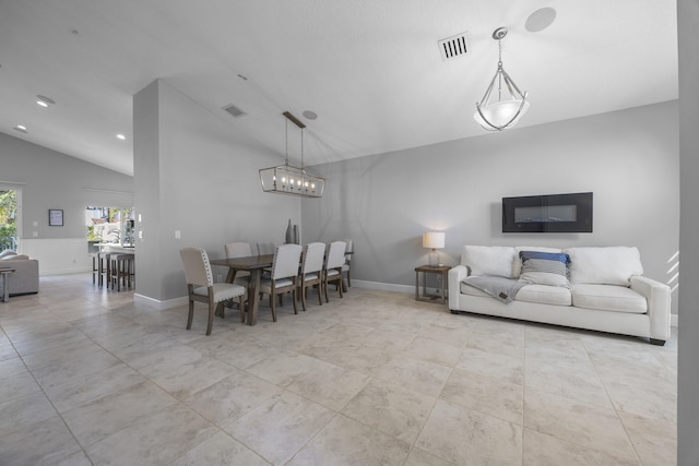 dining area featuring an inviting chandelier and vaulted ceiling