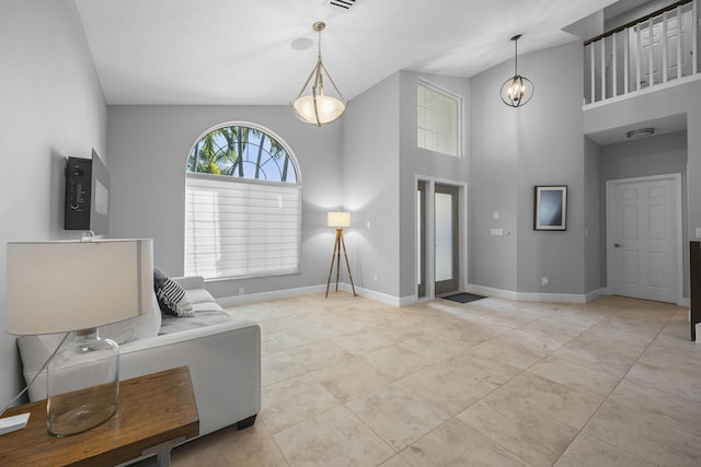 sitting room featuring high vaulted ceiling and a notable chandelier