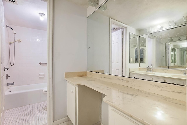 full bathroom featuring vanity, toilet, and tiled shower / bath