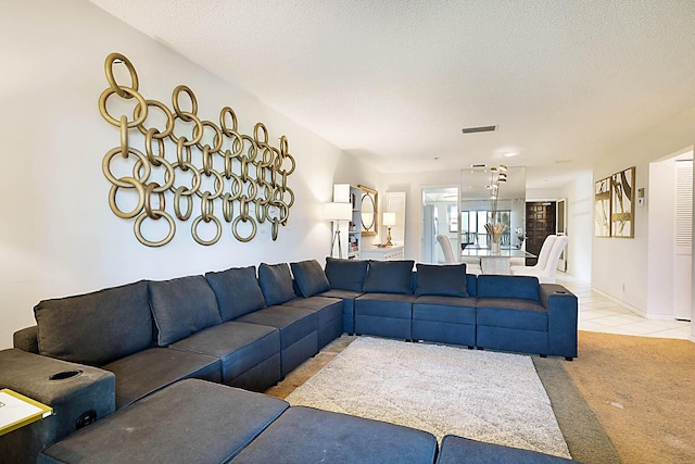 living room featuring light carpet and a textured ceiling