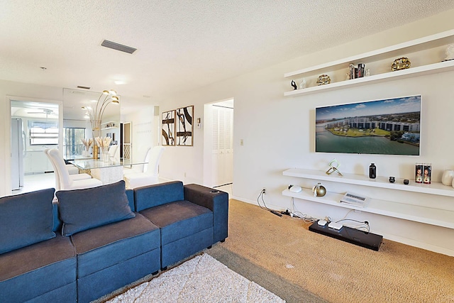 carpeted living room featuring a textured ceiling