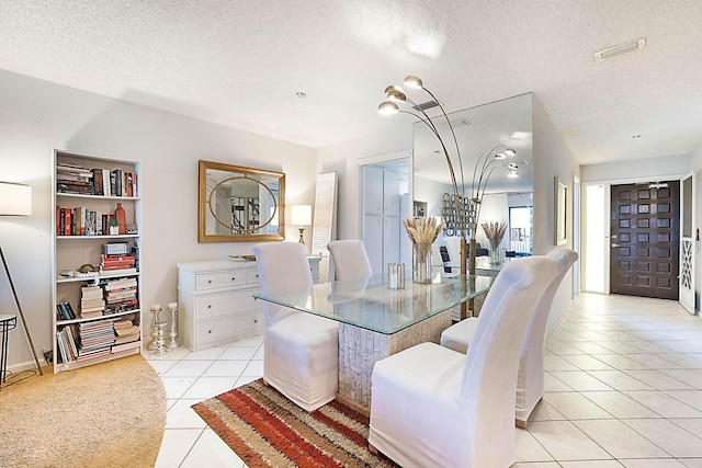 tiled dining room with a textured ceiling