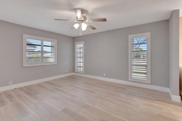 empty room with light hardwood / wood-style floors and ceiling fan