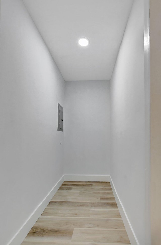 spare room featuring wood-type flooring and electric panel