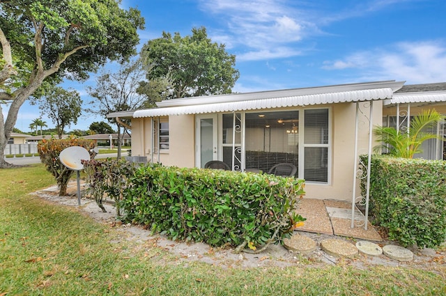 rear view of house featuring a yard