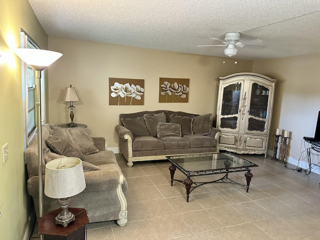 tiled living room with ceiling fan and a textured ceiling