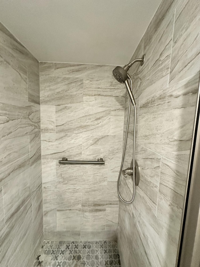 bathroom with a tile shower