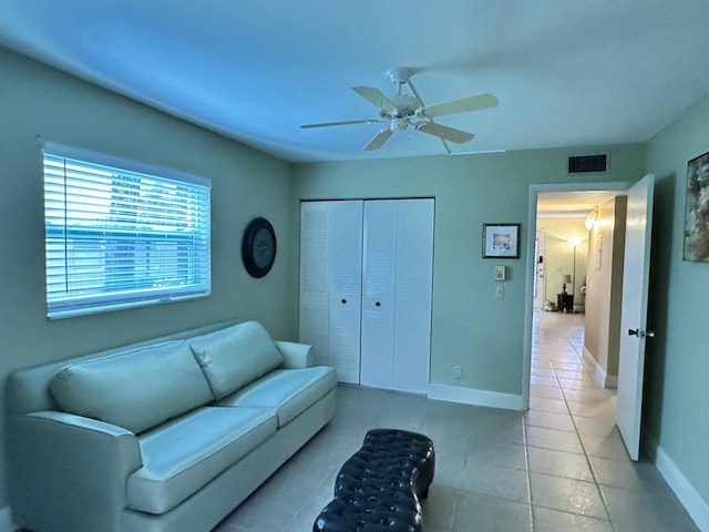 living room featuring ceiling fan and light tile patterned floors