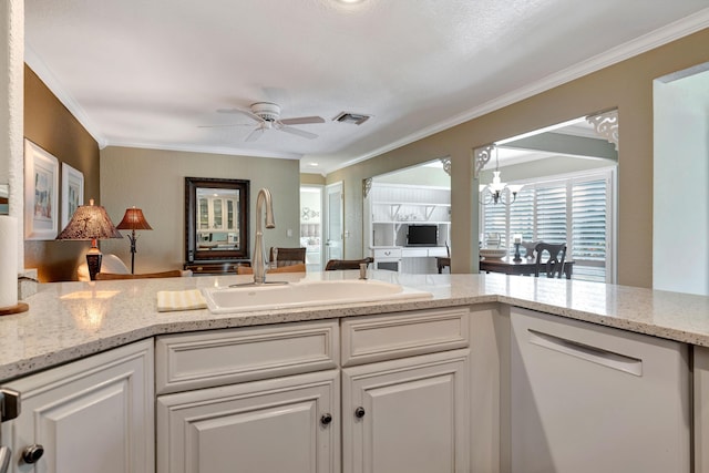 kitchen with ceiling fan with notable chandelier, white cabinetry, sink, white dishwasher, and crown molding