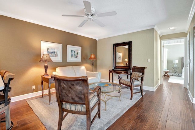 living room featuring crown molding, dark wood-type flooring, and ceiling fan