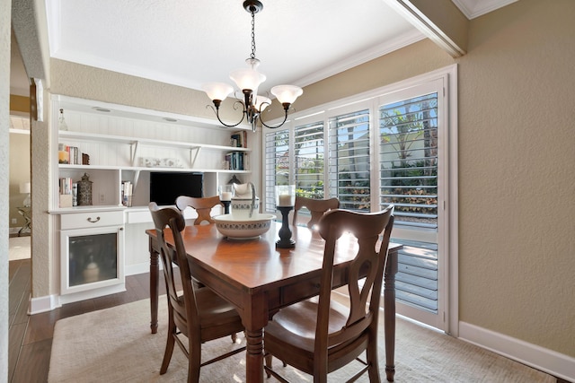 dining area featuring hardwood / wood-style floors, crown molding, and a chandelier