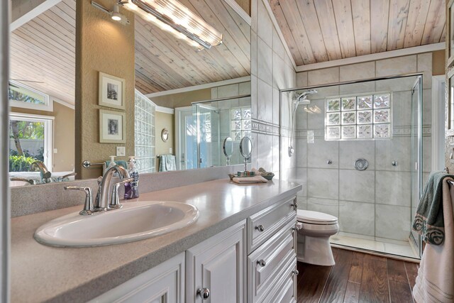 bathroom with lofted ceiling, wood ceiling, hardwood / wood-style floors, vanity, and a tile shower