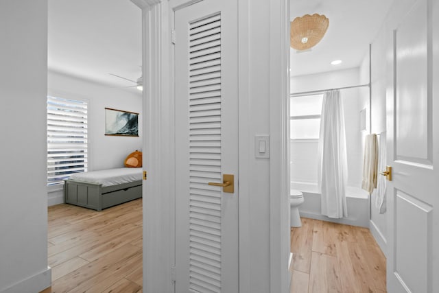 hallway with light hardwood / wood-style floors