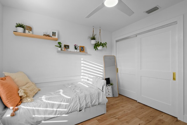 bedroom featuring a closet, ceiling fan, and light hardwood / wood-style flooring