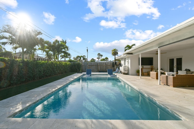 view of pool with ceiling fan, a patio, french doors, and outdoor lounge area