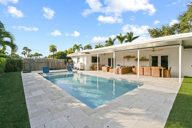 view of pool featuring a patio area, ceiling fan, and an outdoor living space