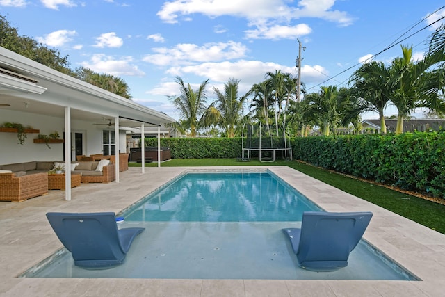 view of swimming pool featuring a trampoline, a patio area, ceiling fan, and an outdoor hangout area