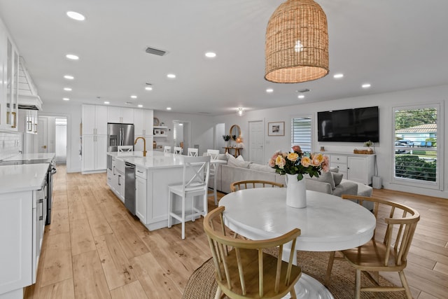 dining area with light hardwood / wood-style floors