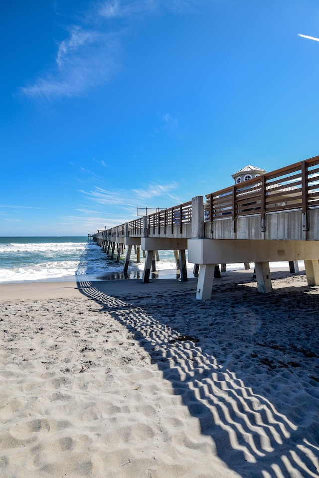 dock area featuring a view of the beach and a water view