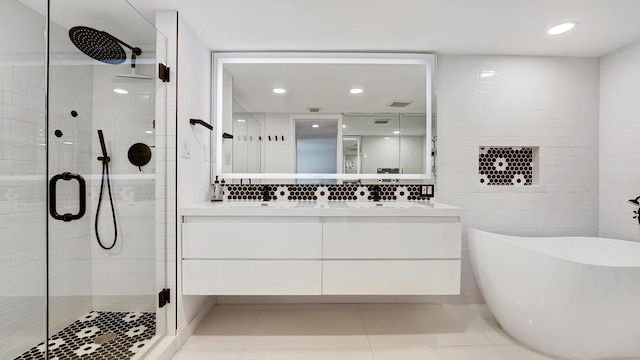 bathroom with separate shower and tub, tile patterned floors, and vanity