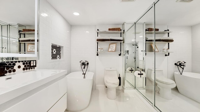 full bathroom featuring tile patterned flooring, separate shower and tub, toilet, and tile walls