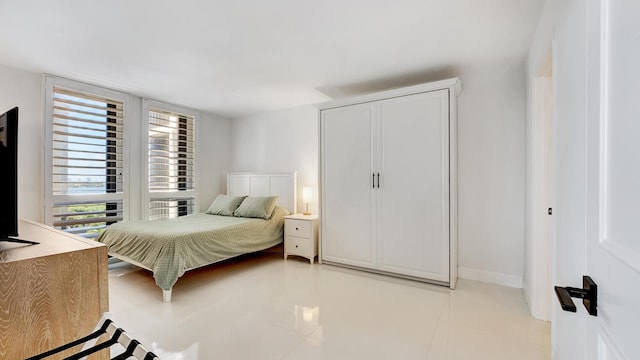 tiled bedroom featuring a closet