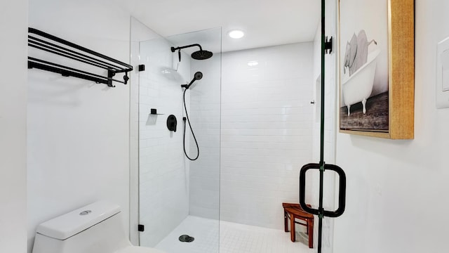 bathroom with an enclosed shower and toilet