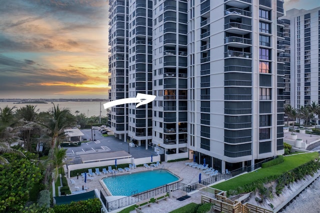 exterior space featuring a community pool and a water view