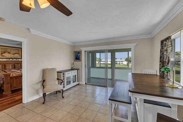 tiled dining area with crown molding and ceiling fan