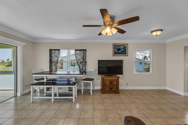 tiled dining room with ceiling fan and ornamental molding