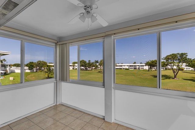 unfurnished sunroom featuring ceiling fan